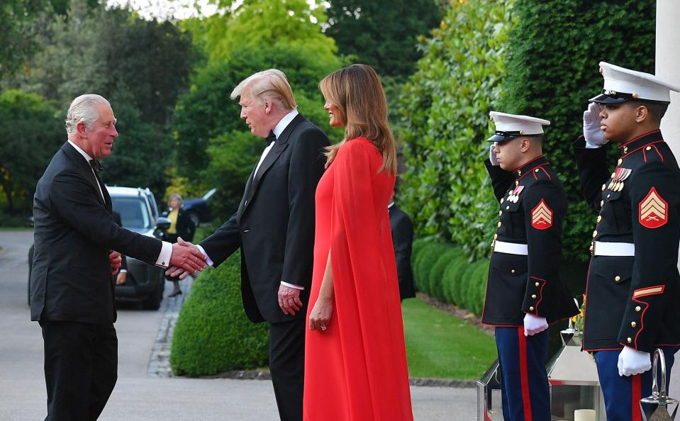 Prince Charles shakes hands with Donald Trump as Melania Trump looks on in 2019