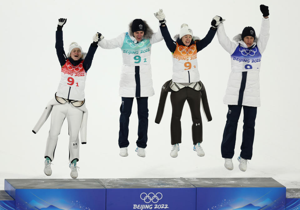 Slovenia jump and celebrate after winning at the Winter Olympics at the Mixed Ski Jump event.