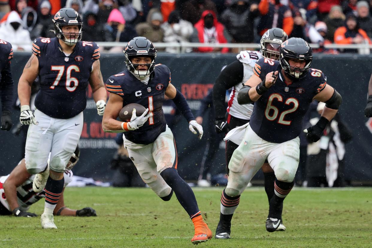 Chicago Bears quarterback Justin Fields (1) rushes the ball against the Atlanta Falcons during the second half at Soldier Field.