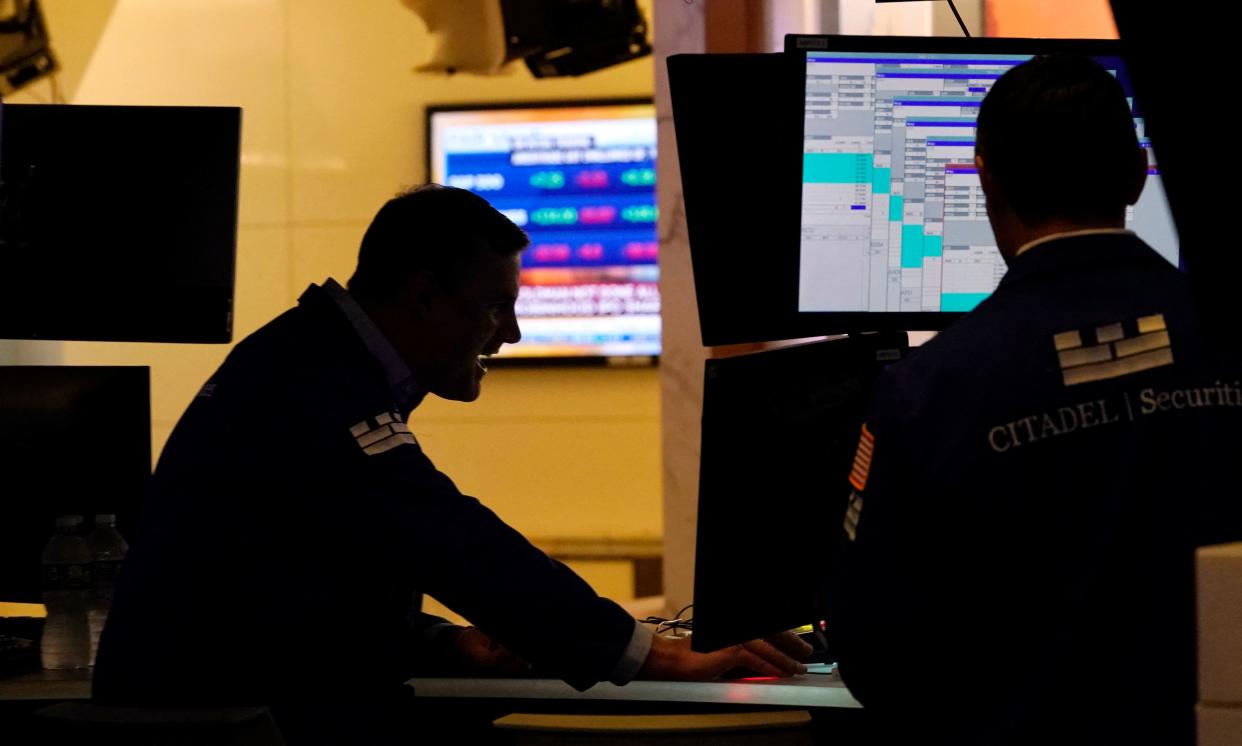 Traders work on the floor at the New York Stock Exchange in New York, on July 29, 2021. - Wall Street stocks climbed early July 29 following another round of mostly strong earnings and US data that showed strong second-quarter growth that lagged expectations. (Photo by TIMOTHY A. CLARY / AFP) (Photo by TIMOTHY A. CLARY/AFP via Getty Images)