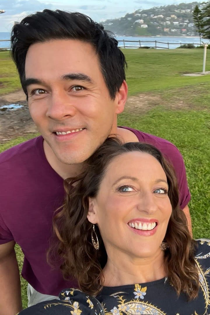 Home and Away stars Georgie Parker (Roo) and James Stewart (Justin) are pictured smiling at the camera on location in Palm Beach