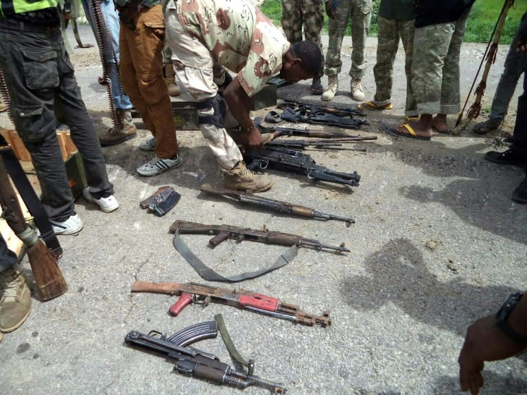 File picture released in July by the Nigerian Army shows a soldier inspecting weapons weized from Islamists Boko Haram fighters