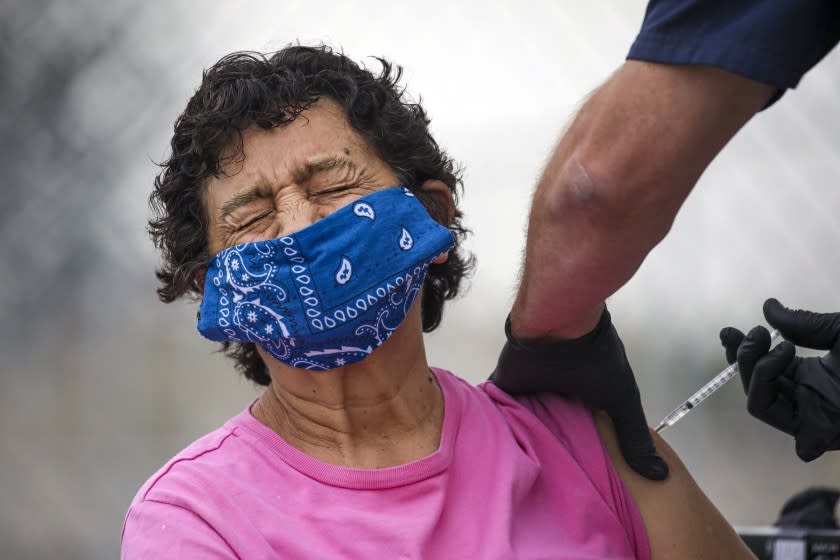 Los Angeles, CA - February 09: Eugenia Solis gets a COVID-19 vaccine at a mobile vaccination site launched by Los Angeles Councilman Curren Price Jr. at South Park Recreation Center on Tuesday, Feb. 9, 2021 in Los Angeles, CA.(Irfan Khan / Los Angeles Times)