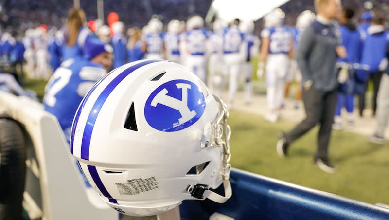 A BYU helmet sits of the sidelines during a game at the LaVell Edwards Stadium field in Provo on Friday, Oct. 28, 2022.