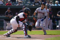 Cleveland Guardians' Steven Kwan, right, prepares to slide into home near Baltimore Orioles catcher Adley Rutschman while scoring a run during the first inning of a baseball game, Wednesday, May 31, 2023, in Baltimore. (AP Photo/Julio Cortez)