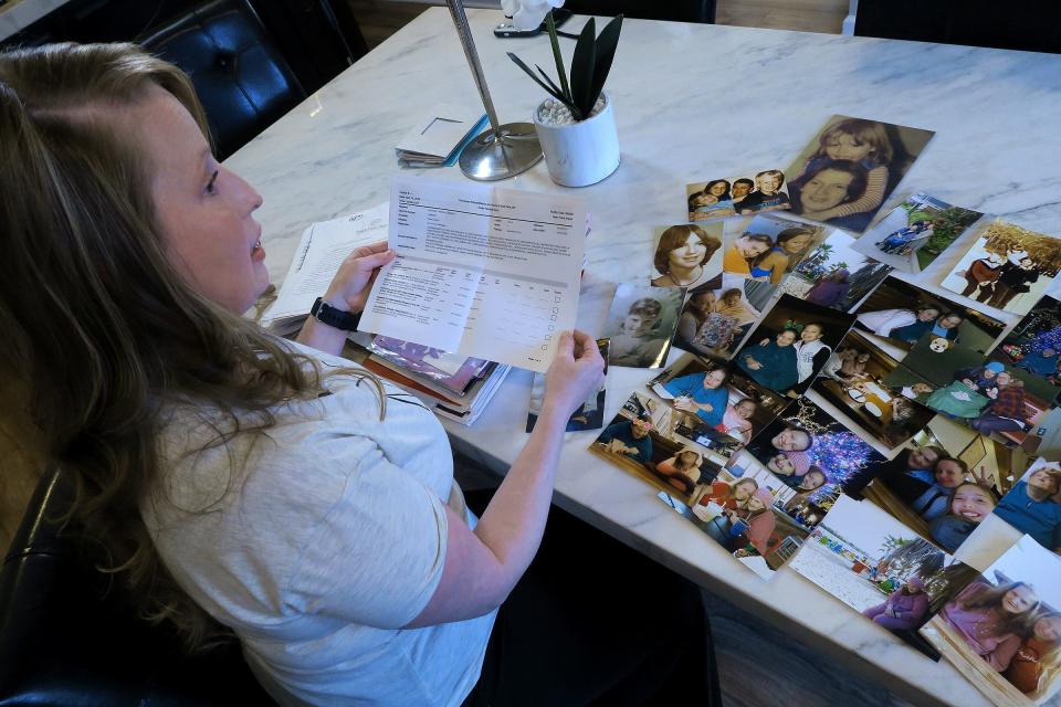 Theresa Sari looks over complaints in her Carteret, NJ, home Wednesday, April 20, 2022, that she filed over the nursing home care that was given to her mother.  Her 60-year-old mother died of COVID in a Long Island nursing home. 