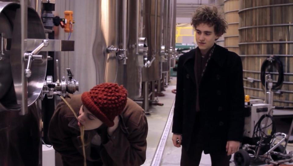 Greta Gerwhig drinks beer from a tank at Dogfish Head's Milton brewery in a scene from the 2011 film "The Dish & the Spoon" as Olly Alexander looks on. 
(Credit: Provided by Humble Pictures)