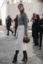 <p> A white skirt may seem best suited to spring summer outfits, however this stylish fashion week guest proves it can be autumn and winter-appropriate too. When paired with a chunky grey knit and black knee-high boots it feels cosy and comforting.  </p>