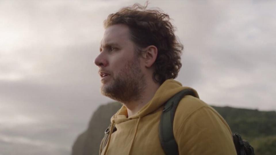 Mark Manson, author of “The Subtle Art of Not Giving a F—” standing on a cliff in the documentary version (Universal Pictures)