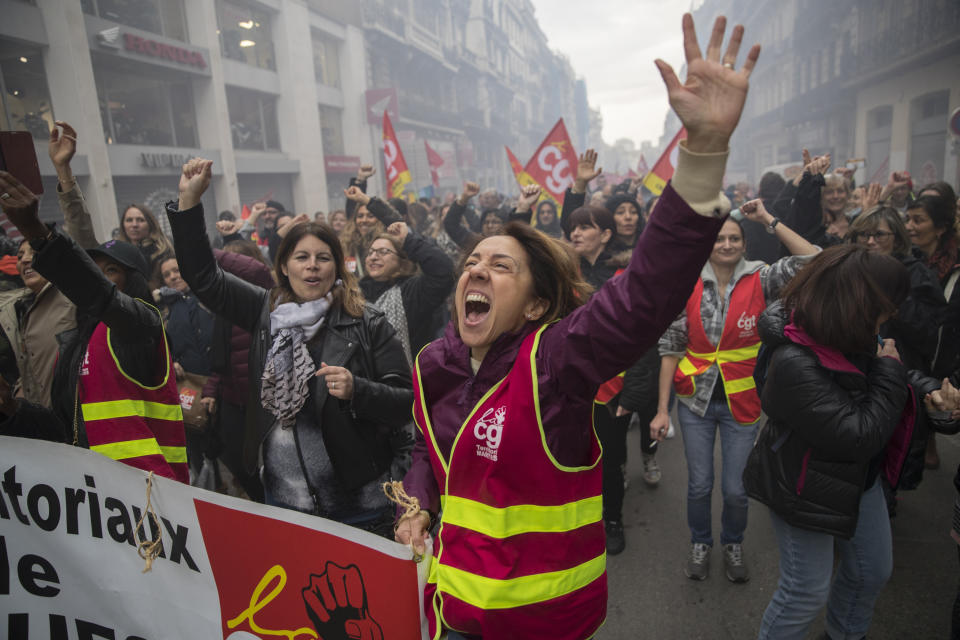 A protester chants slogans during a demonstration in Marseille, southern France, Friday, Jan. 24, 2020. French unions are holding last-ditch strikes and protests around the country Friday as the government unveils a divisive bill redesigning the national retirement system. (AP Photo/Daniel Cole)