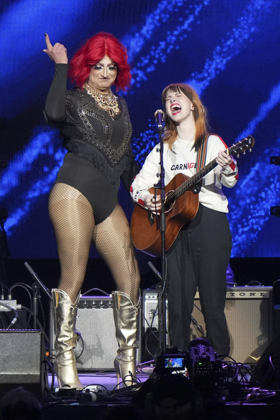 Hayley Williams, right, and Brian O'Connor, who goes by the drag name Sunday Morning, perform at "Love Rising," a benefit concert for the Tennessee Equality Project, Inclusion Tennessee, OUTMemphis and The Tennessee Pride Chamber, on Monday, March 20, 2023, at the Bridgestone Arena in Nashville, Tenn. (Photo by Ed Rode/Invision/AP)