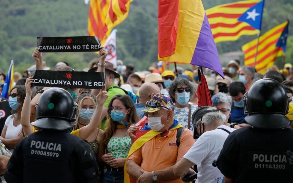 Catalan regional police block an anti-monarchy march - LLUIS GENE/AFP via Getty Images