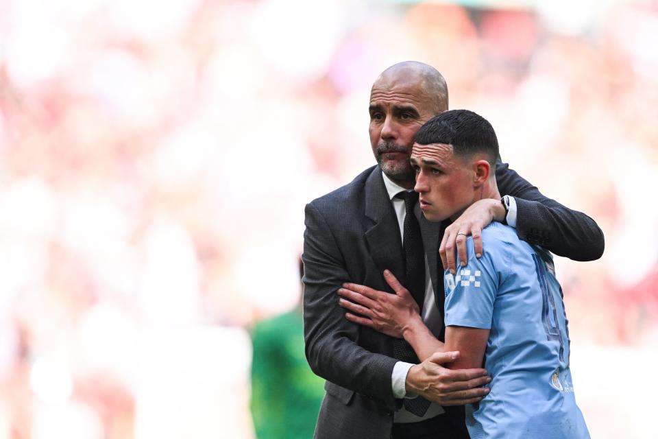 Pep Guardiola consoles Phil Foden after defeat in the Cup final (AFP via Getty Images)