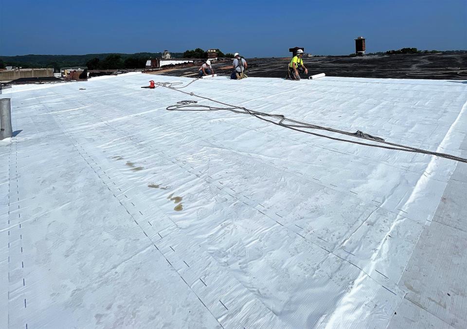 Crews work on the roof of the Selby building. While there is more remodeling to be done, the gaping whole in the roof has been closed and weatherized to prevent any further interior damage.