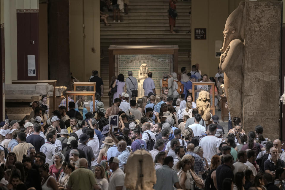 Hundreds of tourists watch and film antiquities at the Egyptian museum in Cairo, Egypt, Wednesday, Sept. 27, 2023. Egypt is aiming at reaching 30 million visitors by 2028, as its once-thriving tourism sector has begun to recover from the fallout of the coronavirus pandemic and the grinding war in Europe, Egypt's Tourism and Antiquities Minister Ahmed Issa said during an interview with the Associated Press. (AP Photo/Amr Nabil)