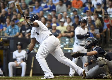 Aug 8, 2018; Milwaukee, WI, USA; Milwaukee Brewers first baseman Jesus Aguilar (24) hits a 3-run homer in the first inning as San Diego Padres catcher Austin Hedges (18) watches at Miller Park. Benny Sieu-USA TODAY Sports