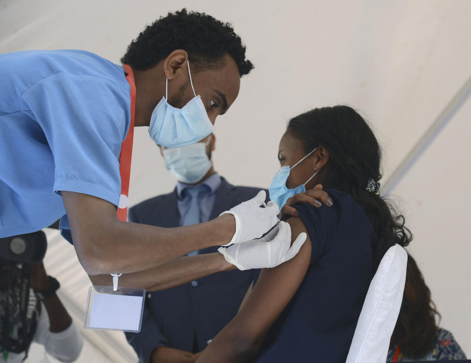 Dr Tenaye Desalegn from the Eka Kobe General Hospital, receives a dose of the AstraZeneca COVID-19 vaccine, in Addias Ababa, Ethiopia, Saturday, March 13, 2021, after the launch of the vaccine in Ethiopia. (AP Photo/Samuel Habitat)