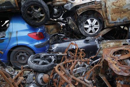 A blue Peugeot car is seen amongst other vehicles and motorcycles at an auto junkyard in Vendenheim near Strasbourg, November 27, 2013. REUTERS/Vincent Kessler