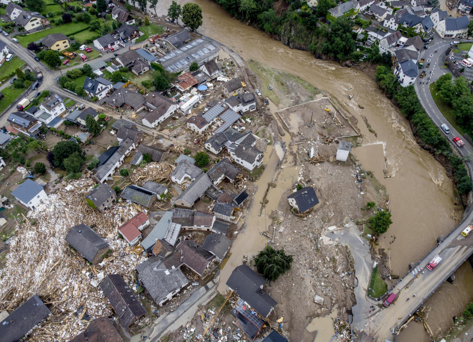 FILE - Debris of a flood lies between destroyed houses near the Ahr river in Schuld, Germany, July 15, 2021. Due to heavy rain falls the Ahr river dramatically went over the banks the evening before. (AP Photo/Michael Probst, File)