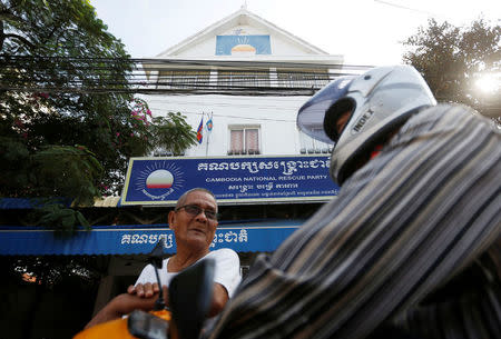 Men stand in front of the Cambodia National Rescue Party (CNRP) headquarters in Phnom Penh, Cambodia, November 17, 2017. REUTERS/Samrang Pring