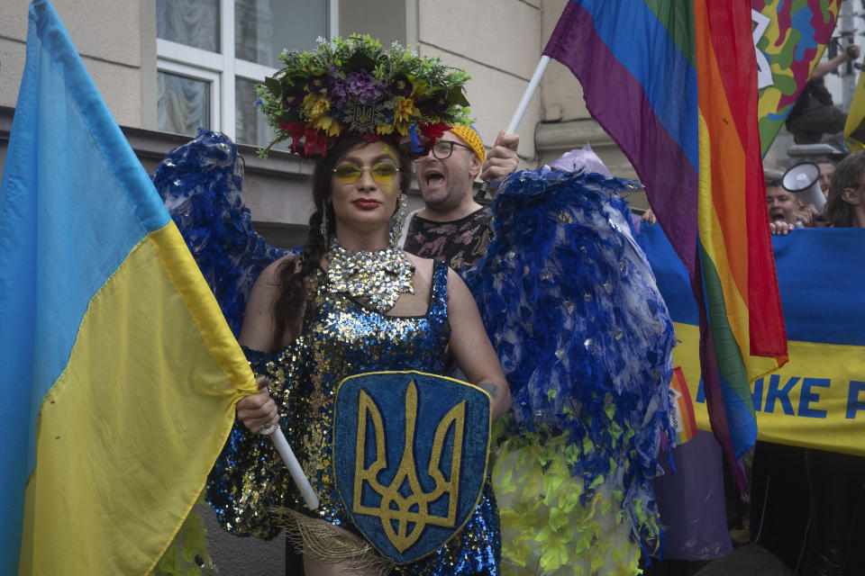 People take part in the annual Gay Pride parade, under the protection of riot police in Kyiv, Ukraine, Sunday, June 16, 2024. Several hundred LGBT Ukrainian servicemen and other protesters joined the pride march in central Kyiv Sunday seeking legal reforms to allow people in same-sex partnerships to take medical decisions for wounded soldiers and bury victims of the war that extended across Ukraine more than two years ago. (AP Photo/Efrem Lukatsky)