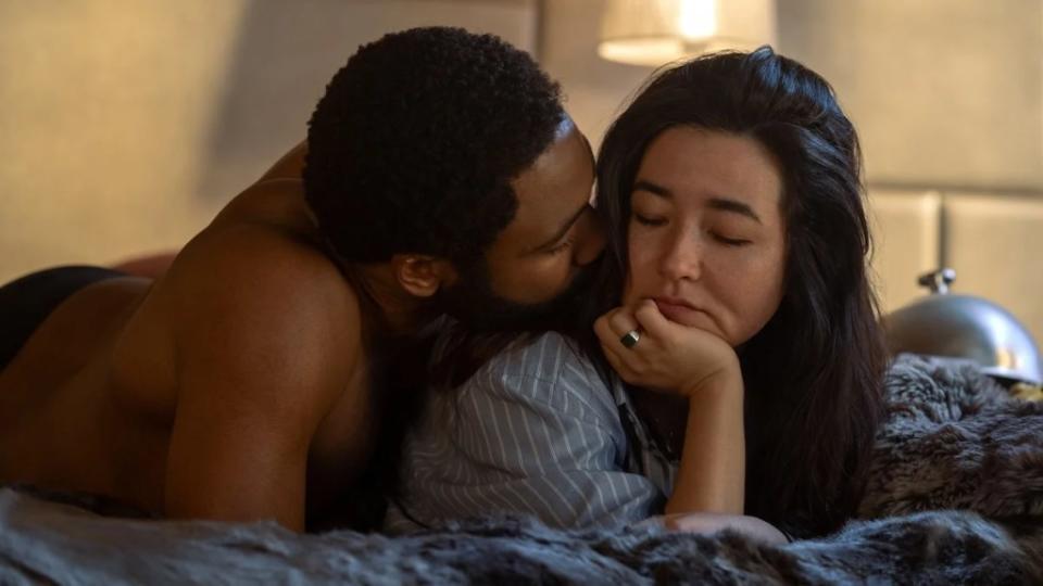Donald Glover and Maya Erksine lay in bed in Mr. and Mrs. Smith