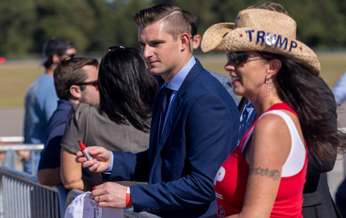 Republican U.S.Rep. District 13 candidate Bo Hines signs an autograph prior to a rally featuring former president Donald Trump, at Wilmington International Airport Friday, Sept. 23, 2022.