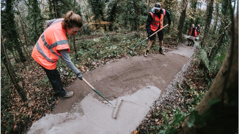 Volunteers laying a new surface on a mountain bike trail at Ashton Court in Bristol