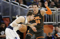 Dallas Mavericks guard Luka Doncic, left, drives around Orlando Magic forward Aaron Gordon (00) during the second half of an NBA basketball game, Friday, Feb. 21, 2020, in Orlando, Fla. (AP Photo/John Raoux)