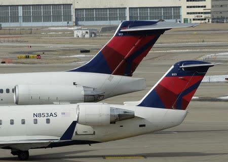 Two delta Airlines jets sit at their gates at the Lambert - St. Louis International Airport, in St. Louis, Missouri, March 4, 2013. REUTERS/Tom Gannam