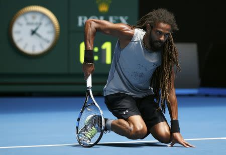 Tennis - Australian Open - Melbourne Park, Melbourne, Australia - 17/1/17 Germany's Dustin Brown rests on the court during his Men's singles first round match against Canada's Milos Raonic. REUTERS/Issei Kato