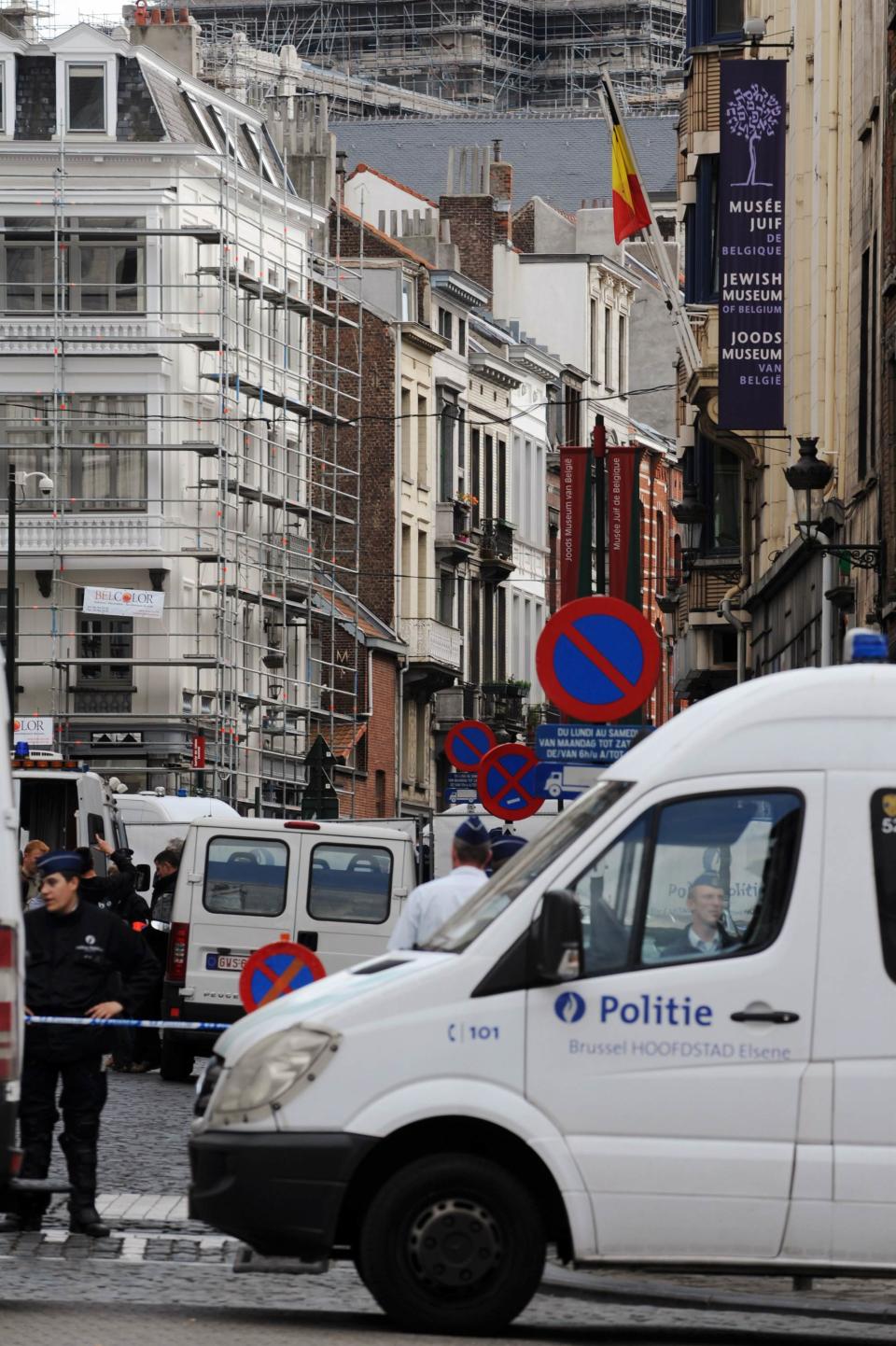Police are seen at the site of a shooting in Brussels