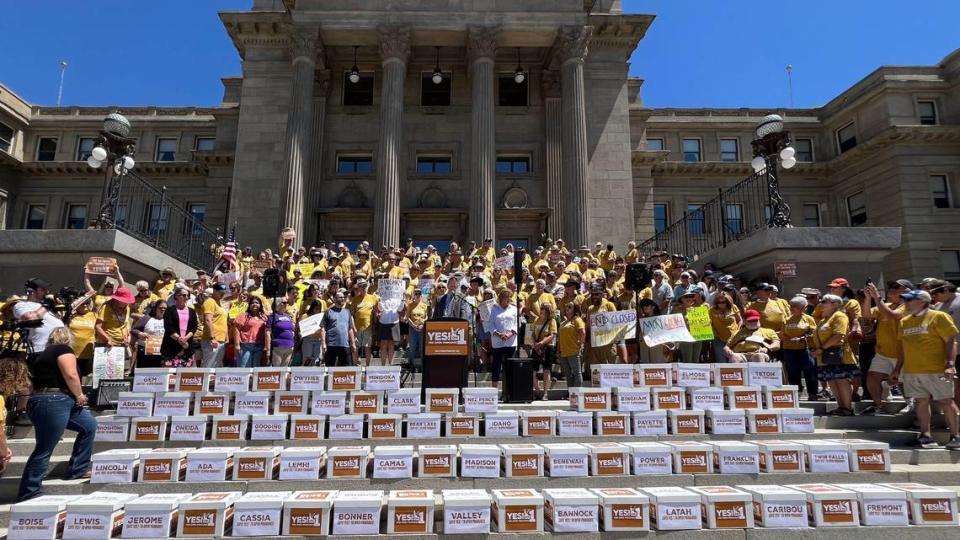 Idahoans for Open Primaries volunteers stand with boxes from every county in Idaho filled with signatures to deliver to the Idaho Secretary of State’s Office at the Capitol on Tuesday.