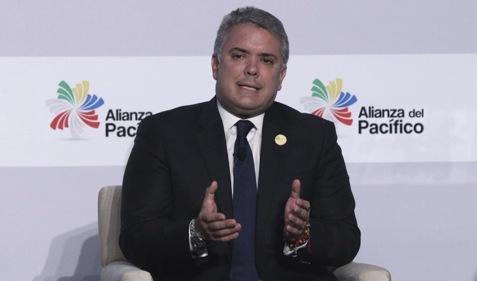 FILE - In this July 5, 2019 file photo, Colombia's President Ivan Duque speaks during a Pacific Alliance Summit in Lima, Peru. A group of former peace negotiators for the Revolutionary Armed Forces of Colombia announced Thursday, Aug. 28, they are taking up arms again following what they considered the failure of Duque to guarantee their political rights after the signing of a landmark peace deal. (AP Photo/Martin Mejia, File)