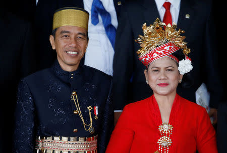 Indonesia president Joko Widodo stand between parliament members after delivering a speech in front of parliament members ahead of Thursday's independence day in Jakarta, Indonesia, August 16, 2017. REUTERS/Beawiharta