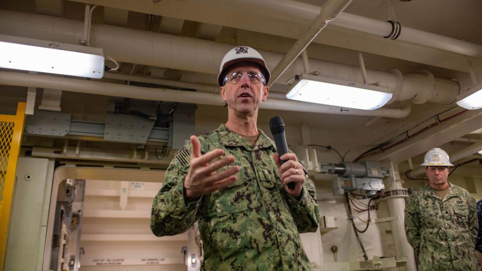 Then-Chief of Naval Operations Adm. John Richardson talks to the media in front of one of a ship's new weapons elevator. (Staff)