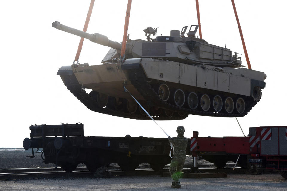 In this file photo taken on February 14, 2017, a US soldier helps to maneuver an Abrams tank from a railway car as US Army personnel offload military equipment at the Mihail Kogalniceanu Air Base near Constanta in Romania. - US President Joe Biden will address Americans on January 25, 2023, about US support for Ukraine, the White House announced, amid expectations that the US will announce future delivery of Abrams tanks. The White House gave no details of the remarks scheduled for 12:00 pm (1700 GMT), other than saying Biden 