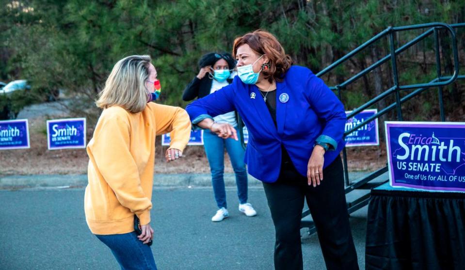 Erica Smith, right, elbow bumps a supporter during her 2022 U.S Senate campaign launch event Saturday, March 8, 2021 at Hillside High School in Durham. Smith is running on an unabashedly progressive platform, embracing Medicare for All, universal basic income, the Green New Deal and canceling all student loan debt.