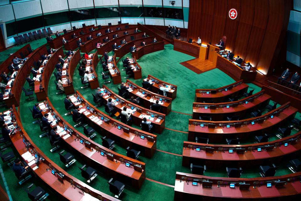 FILE - In this Wednesday, March 17, 2021, file photo, Hong Kong Chief Executive Carrie Lam listens to questions during a question and answer session at the Legislative Council in Hong Kong. China's top legislature approved amendments to Hong Kong's constitution on Tuesday, March 30, that will give Beijing more control over the make-up of the city's legislature. (AP Photo/Vincent Yu, File)