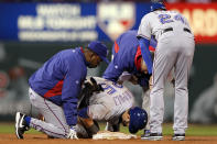 ST LOUIS, MO - OCTOBER 27: Mike Napoli #25 of the Texas Rangers is tended to by manager Ron Washington after rolling his ankle sliding into second base after a throwing error by pitcher Fernando Salas #59 of the St. Louis Cardinals in the fourth inning during Game Six of the MLB World Series at Busch Stadium on October 27, 2011 in St Louis, Missouri. (Photo by Jamie Squire/Getty Images)
