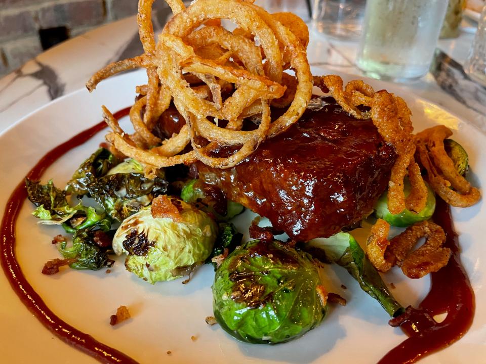 The Southwestern Meatloaf at Kingston's Maple Creek Bistro is an 8-ounce medallion of brisket meatloaf glazed with homemade barbecue sauce and served with Sweetwater Valley cheddar cheese, bacon, tobacco onions and a choice of sides (in this case, Brussels sprouts).