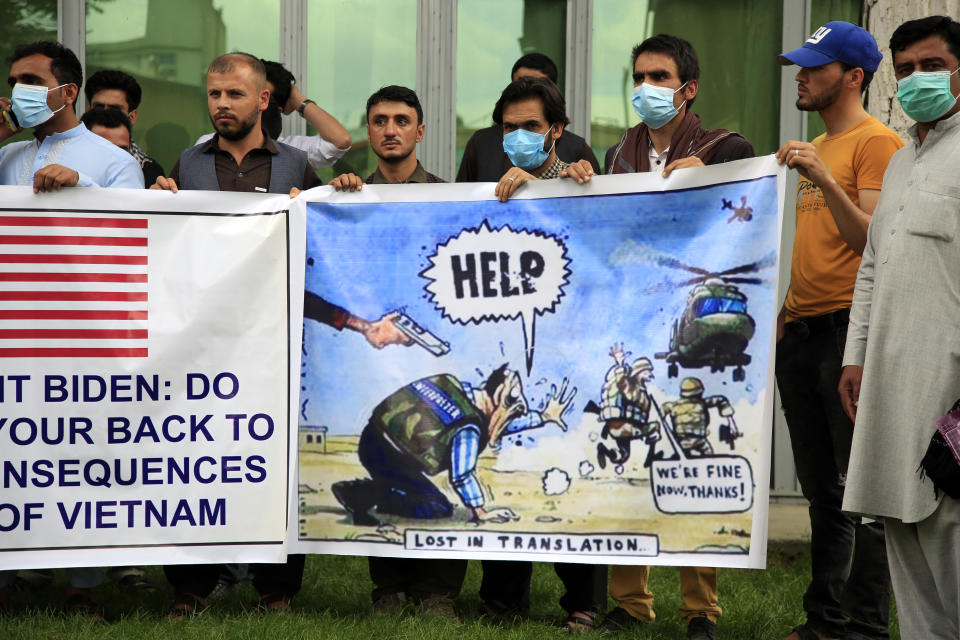 In this Friday, April 30, 2021, photo former Afghan interpreters hold banners during a protest against the U.S. government and NATO in Kabul, Afghanistan. (AP Photo/Mariam Zuhaib)