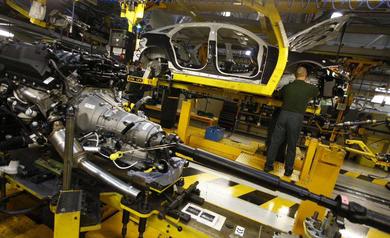 Staff work on the Jaguar XJ production line at their Castle Bromwich Assembly Plant in Birmingham November 29, 2011. REUTERS/Eddie Keogh (BRITAIN - Tags: TRANSPORT BUSINESS)