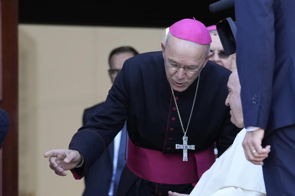 Pope Francis talks with Bishop Athenasius Schneider, auxiliary bishop of Astana, as he arrives for a meeting with priests, religious men and women, seminarians and catechists at the Our Lady Of Perpetual Help Cathedral in Nur-Sultan, Kazakhstan, Thursday, Sept. 15, 2022. Pope Francis is on the third day of his three-day trip to Kazakhstan. (AP Photo/Andrew Medichini)