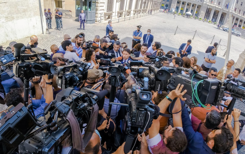 Former Italian Premier and 5-Star Movement Leader Giuseppe Conte, center, talks to journalists outside Chigi Palace government offices in Rome, Wednesday, July 6, 2022, after meeting with Italian premier Mario Draghi. Conte met for more than an hour Wednesday with Premier Mario Draghi, who has made plain that if Conte pulls yank the support of his 5-Star Movement, the pandemic unity government would be finished. (Mauro Scrobogna/Lapresse via AP)