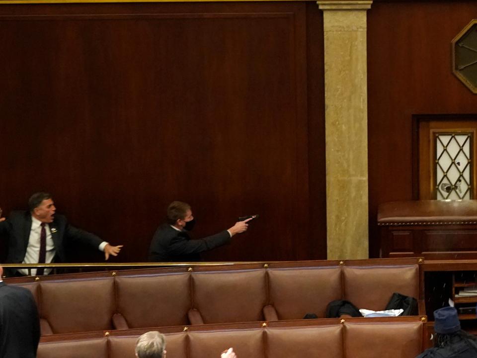 <p>Andrew Clyde (left) in the House chamber on 6 January</p> (Getty)