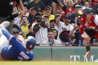 Fans reacts as Boston Red Sox's Christian Vazquez, right, picks off Toronto Blue Jays' Reese McGuire at home plate during the second inning of a baseball game, Saturday, June 12, 2021, in Boston. (AP Photo/Michael Dwyer)