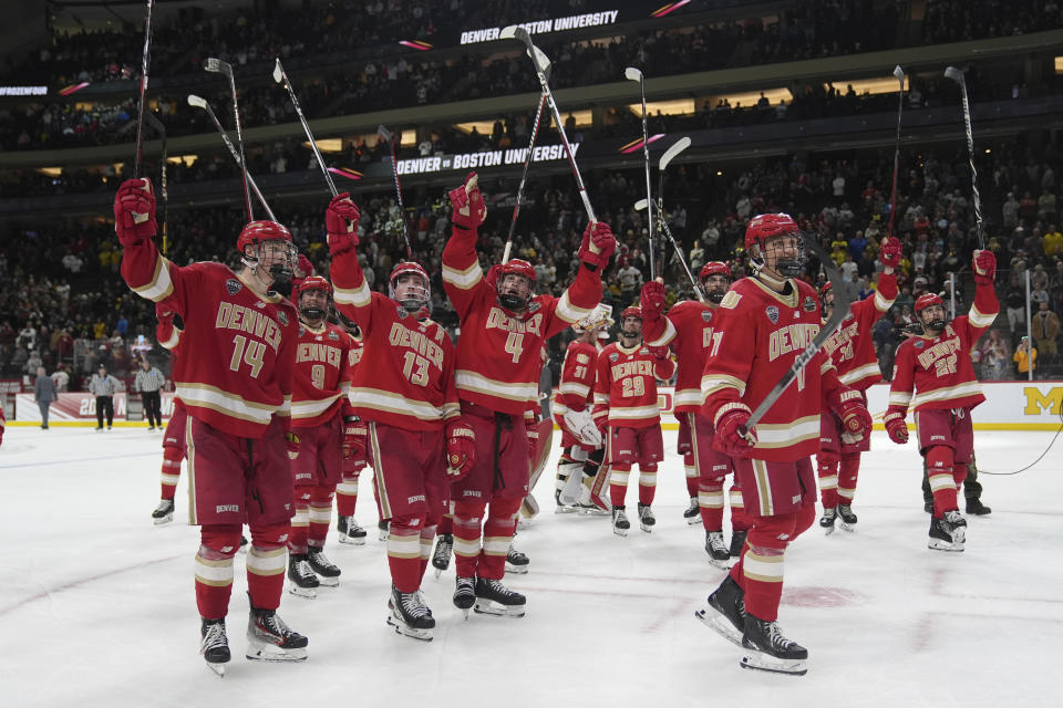Denver players celebrate after an overtime win against Boston University in a semifinal game at the Frozen Four NCAA college hockey tournament Thursday, April 11, 2024, in St. Paul, Minn. (AP Photo/Abbie Parr)