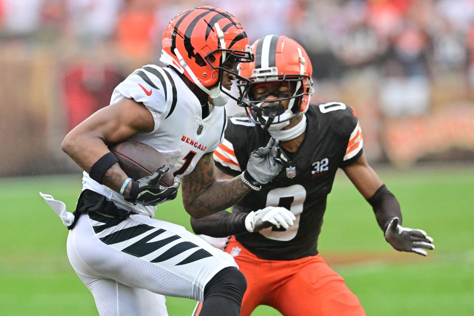 Sep 10, 2023; Cleveland, Ohio, USA; Cincinnati Bengals wide receiver Ja'Marr Chase (1) runs with the ball after a catch as Cleveland Browns cornerback Greg Newsome II (0) defends during the first half at Cleveland Browns Stadium. Mandatory Credit: Ken Blaze-USA TODAY Sports