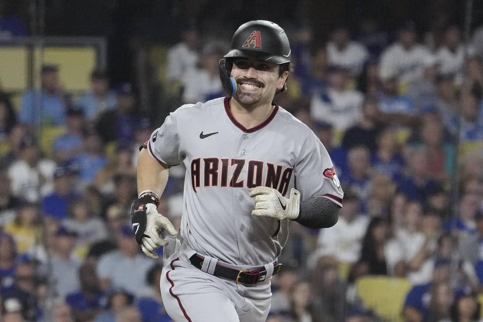 FILE - Arizona Diamondbacks' Corbin Carroll smiles as he rounds the bases after hitting a home run during the second inning in Game 1 of a baseball NL Division Series against the Los Angeles Dodgers, Saturday, Oct. 7, 2023, in Los Angeles. Seattle center fielder Julio Rodriquez will receive the largest amount in the $50 million pool for pre-arbitration players, earning $1,865,349. Arizona outfielder Corbin Carroll is second at $1,812,337, according to figures compiled by Major League Baseball and the players’ association. (AP Photo/Mark J. Terrill, File)